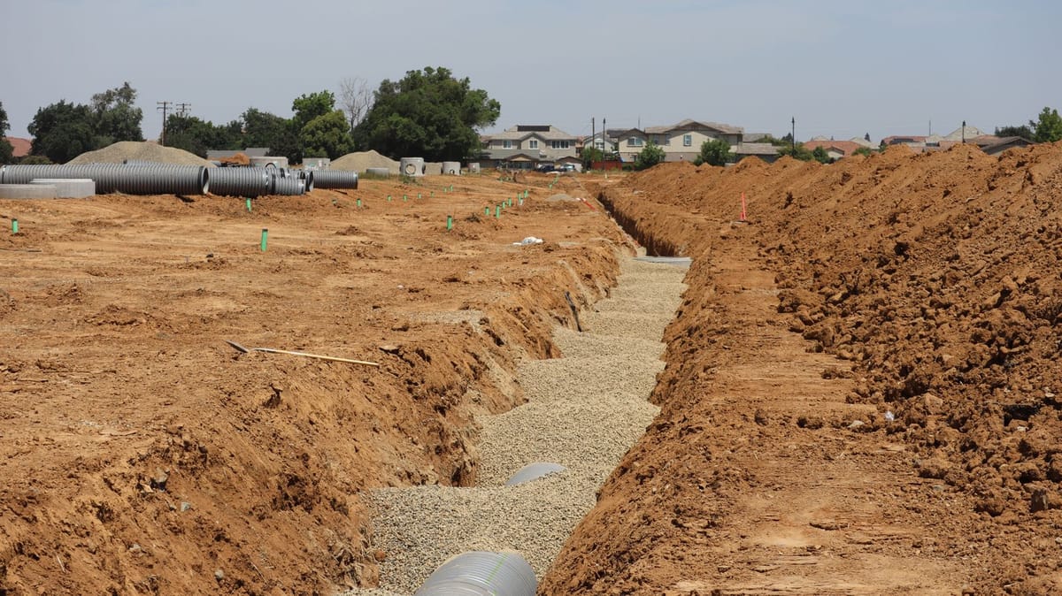 A raised mound septic system under construction with specified fill sand